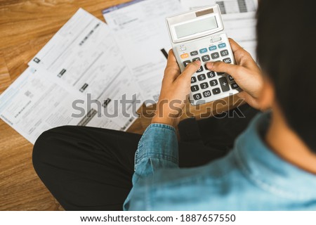 Top view man sitting on the floor stressed and confused by calculate expense from invoice or bill, have no money to pay thinking of taking the house to mortgage causing debt, bankruptcy concept. Photo stock © 