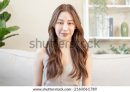 Similar – Image, Stock Photo Pretty brunette, long-haired young woman, teenager, teenager smiles naturally into the camera, in front of a grey wall on vacation. Happy girl with blue eyes, in front of a rock by the sea, on the beach during the summer holidays, looking forward to holidays and summer fun.