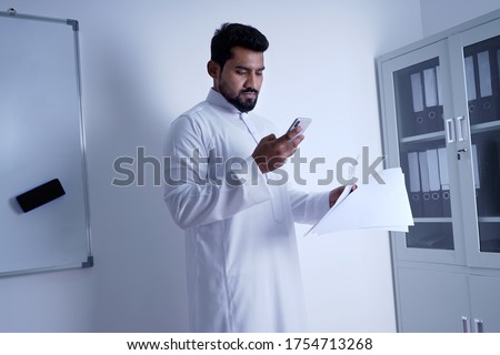 Similar – Image, Stock Photo Islamic man using smartphone on street