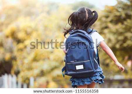 Back to school. Cute asian child girl with backpack running and going to school with fun 商業照片 © 