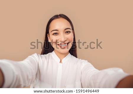 Similar – Image, Stock Photo Asian female taking selfie in underground passage