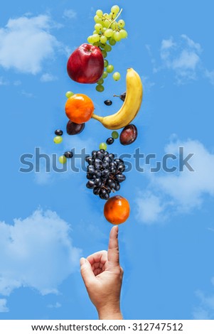 Fresh fruit balancing on a human hand. Concept of healthy food.