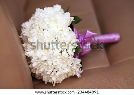 Pastel wedding bouquet with chrysanthemum on brown skin