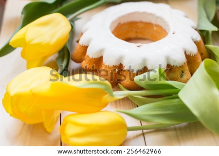 Easter cake and bunch of  yellow tulips