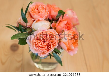 Beautiful wedding peach pastel bouquet of roses on wooden background