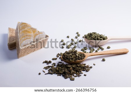 Leaf tea in a wooden spoon and tea bags in  box.