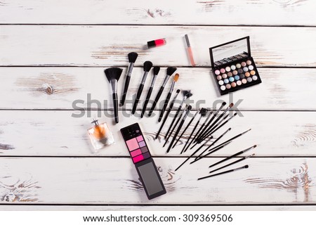 Set of female cosmetics on a white wooden background. Still life of cosmetics.
