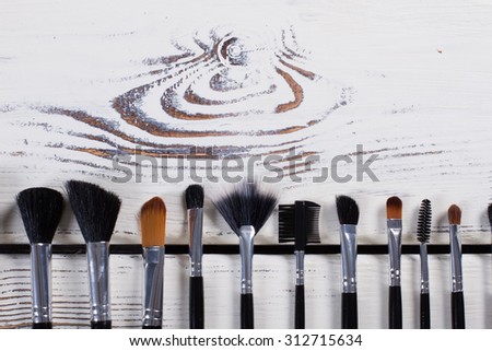 Many different brush for face on a white wooden background. Set of brushes.