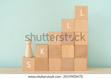 SKILL; Wooden blocks with 'SKILL' text of concept and a human toy. Foto d'archivio © 