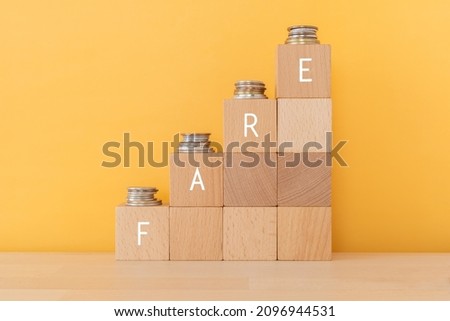 Wooden blocks with 'FARE' text of concept and coins. Stock foto © 