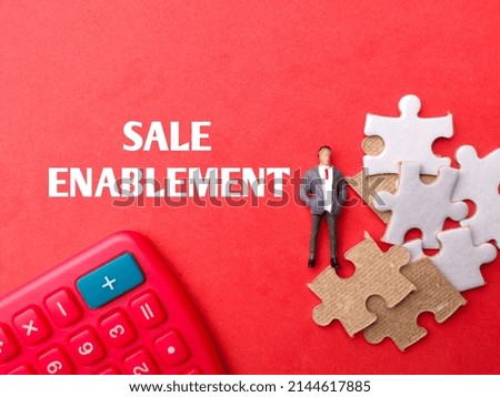 Calculator,miniture people and puzzle with text SALE ENABLEMENT on red background Stock foto © 