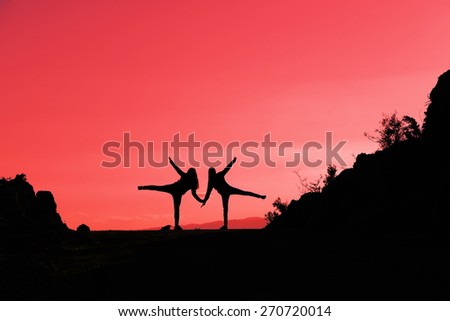 silhouettes of people on mountains
