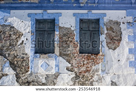 Two classic jalousie windows in old house wall.\
Old house windows.