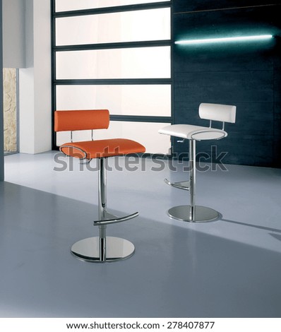 leather stools and steel,bar stools,stools tires leather and steel of modern design with metallic finish at the edges, back in leather and polished steel base,artificial light,