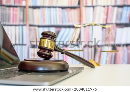 Legal office of lawyers, justice and law concept : Judge gavel or a hammer and a base used by a judge person on a desk in a courtroom with blurred weight scale of justice. Stock foto © 