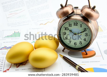 Three golden eggs with a clock on business and financial reports : Investment concept
