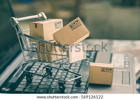 Cartons in a shopping cart on a laptop keyboard. Ideas about online shopping, online shopping is a form of electronic commerce that allows consumers to directly buy goods from a seller over internet. Stock foto © 