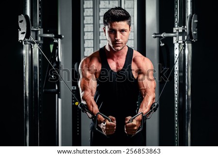 handsome bodybuilder works out  pushing up excercise in gym