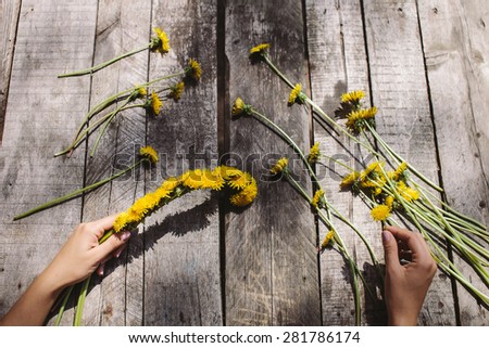 flower decoration of dandelions and irise lilac flowers handmade on vintage wood table