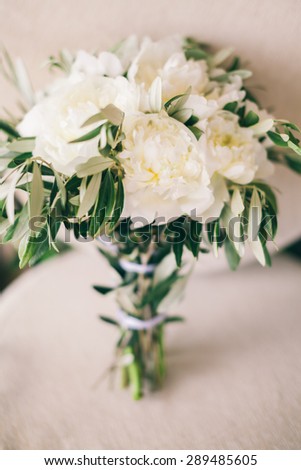 wedding bouquet white peony on armchair pastel background in fine art style