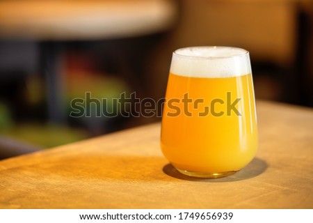 Hazy NEIPA New England IPA pale ale beer, on wood surface, rich frothy foam head with copy space Stok fotoğraf © 