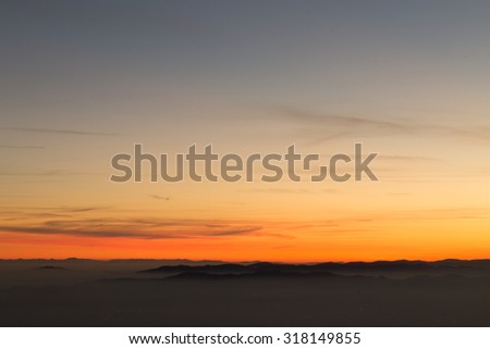 Mountain silhouette over clouds, sky background, wallpaper