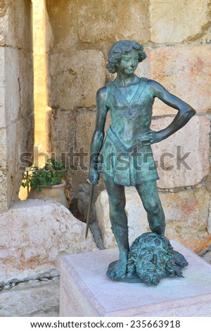 the statue of a young king David who in a fight with a blow of a stone cast it into the earth huge Goliath and then beheaded him