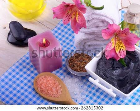clay for Spa treatments stones for massage oil and flowers and bark of oak and towel