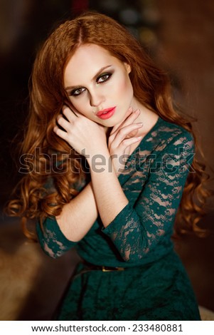 Portrait of red-haired sensual girl with a green dress, close up