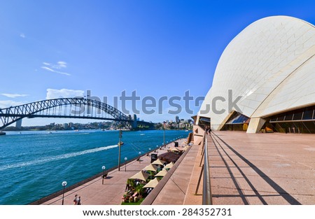 Sydney, Australia - January 23, 2015: Sydney Opera House and Harbor Bridge in a sunny day on January 23, 2015 in Sydney, Australia.