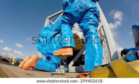 HAIFA, ISRAEL - JUNE 30, 2015: Firefighters from Northern Israel with protective gear pump air to patch during simulation drill of leak of Bromine chemical in a container car of train