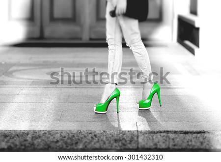 girl in jeans on a green heels