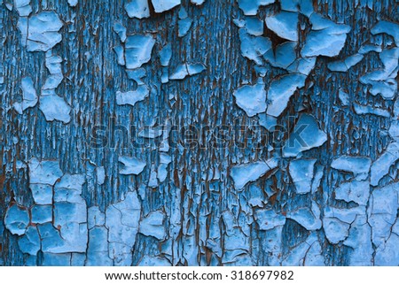 wooden wall, painted an old dark blue paint that falls off