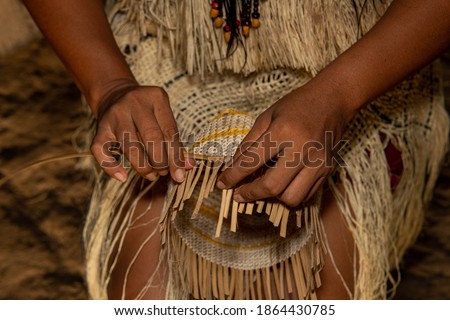 Hands of indigenous woman from the Huitoto tribe of the Colombian Amazon making traditional weaving of a basket Photo stock © 