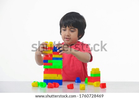 Similar – Image, Stock Photo Children playing with their toys on a wooden floor