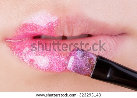 Pink glitter on natural lips. Close-up . Great idea for advertising lip gloss.