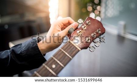 Similar – Image, Stock Photo male hand musician tunes guitar close up