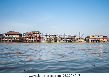 INLE LAKE, MYANMAR - APRIL 10: Floating houses in a village on APRIL 10, 2012 in Inle Lake, Myanmar. Inle lake is a famous lake for tourism in Myanmar.