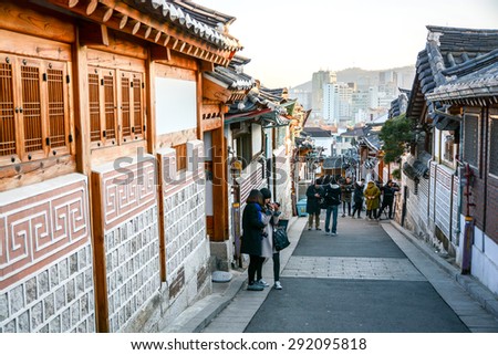 SEOUL, SOUTH KOREA - OCTOBER 2, 2014 : Tourists walk in the beautiful scenery around Bukchon Hanok Village,Traditional Korean style architecture in Seoul, South Korea.