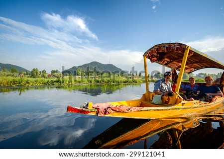 SRINAGAR, INDIA - JULY 11, 2014 : Lifestyle in Dal lake, people who come here use Shikara, a small boat for tourism in the lake of Srinagar, Jammu and Kashmir state, India