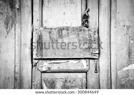 Gray (grey) grunge broken wood panel on antique weathered door