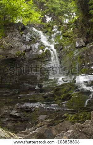 Natural water falling on moss laden rock
