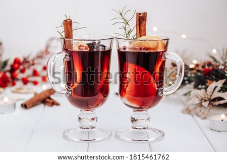 Two glasses of mulled wine on the table surrounded by New Year's lights. Festive mood Сток-фото © 