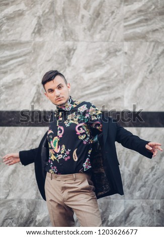 Portrait of young handsome stylish man. Outdoor fashion portrait.