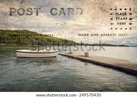 Small boat on a sea, with beautiful clouds on an old postcard