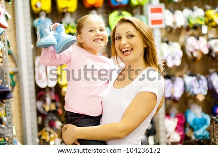 mother and daughter shopping for shoes