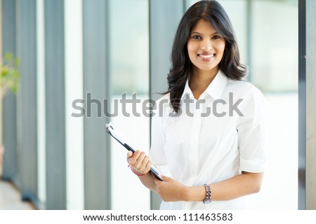 attractive modern young indian businesswoman in office