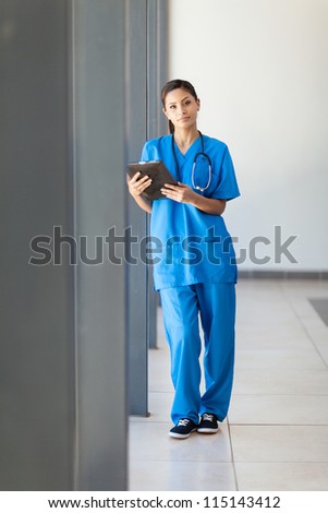 young female healthcare worker using tablet computer in hospital