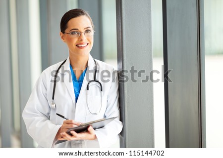beautiful female healthcare worker writing report in office