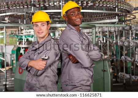 two textile industrial technicians portrait in factory